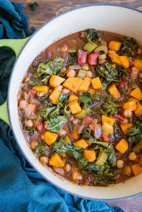 Butternut Squash and Chickpea Chili with Kale in a large pot with a blue napkin to the side, ready to serve.