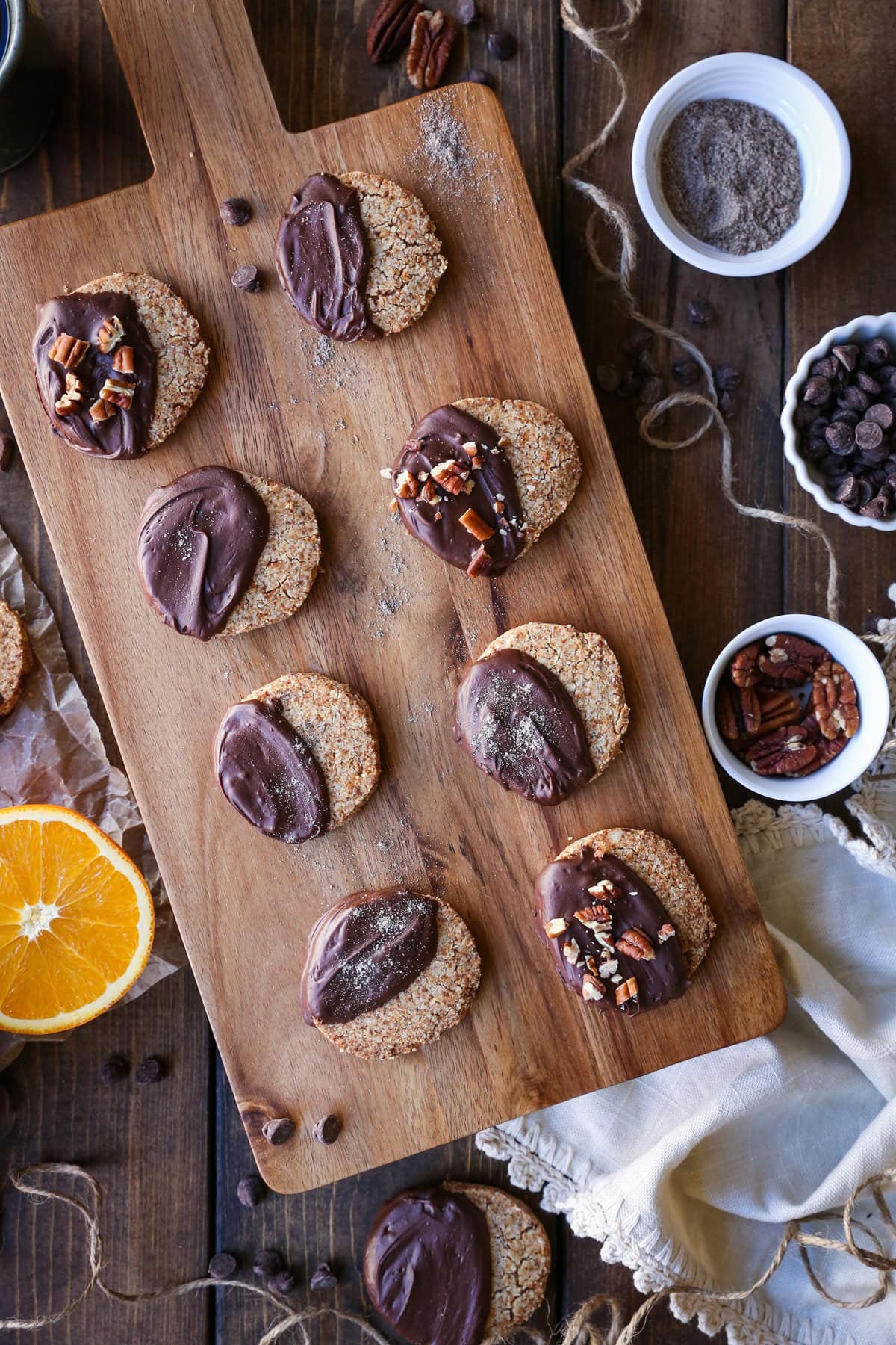 Cutting board with chocolate dipped shortbread cookies.