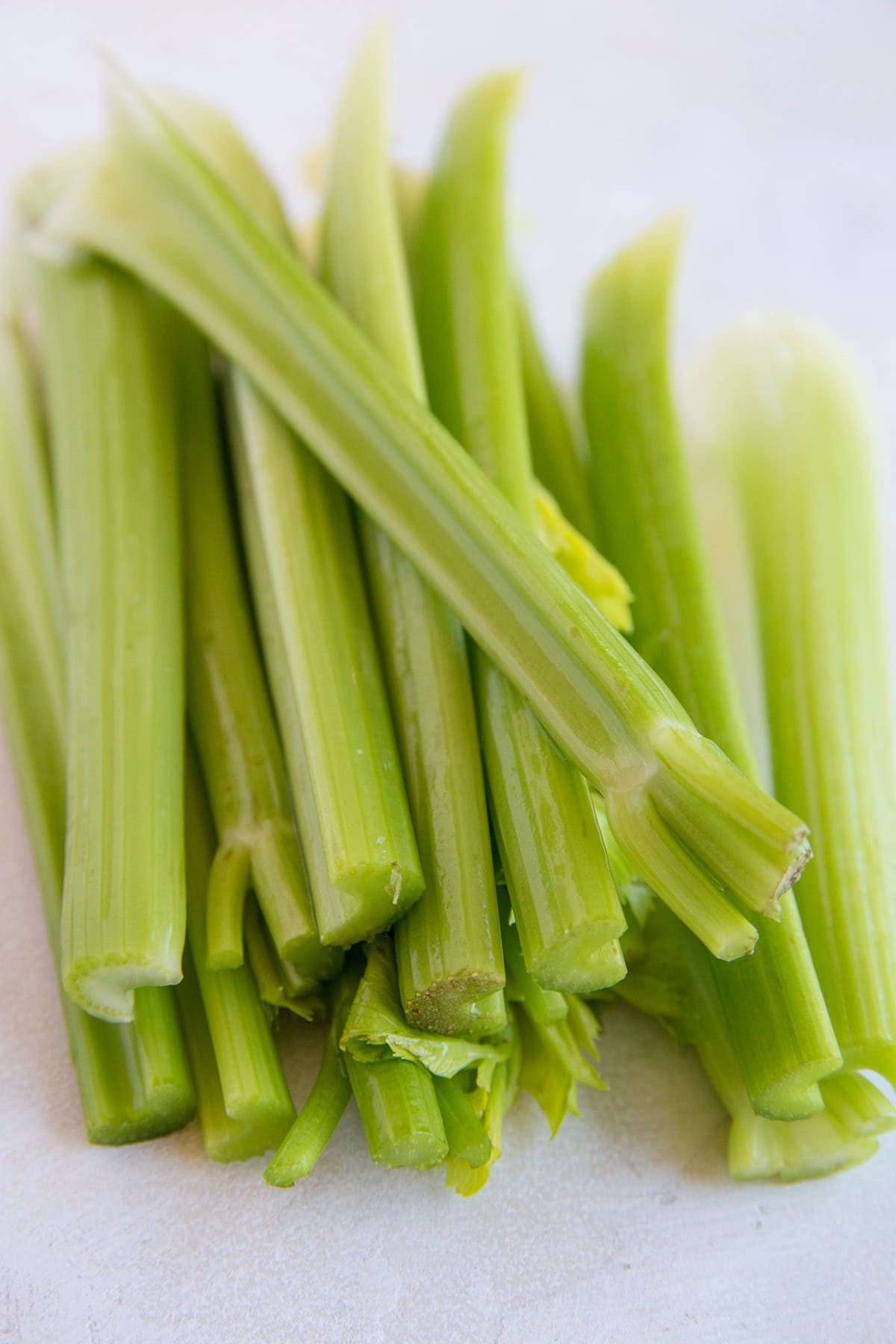 Head of celery cut on a cutting board.
