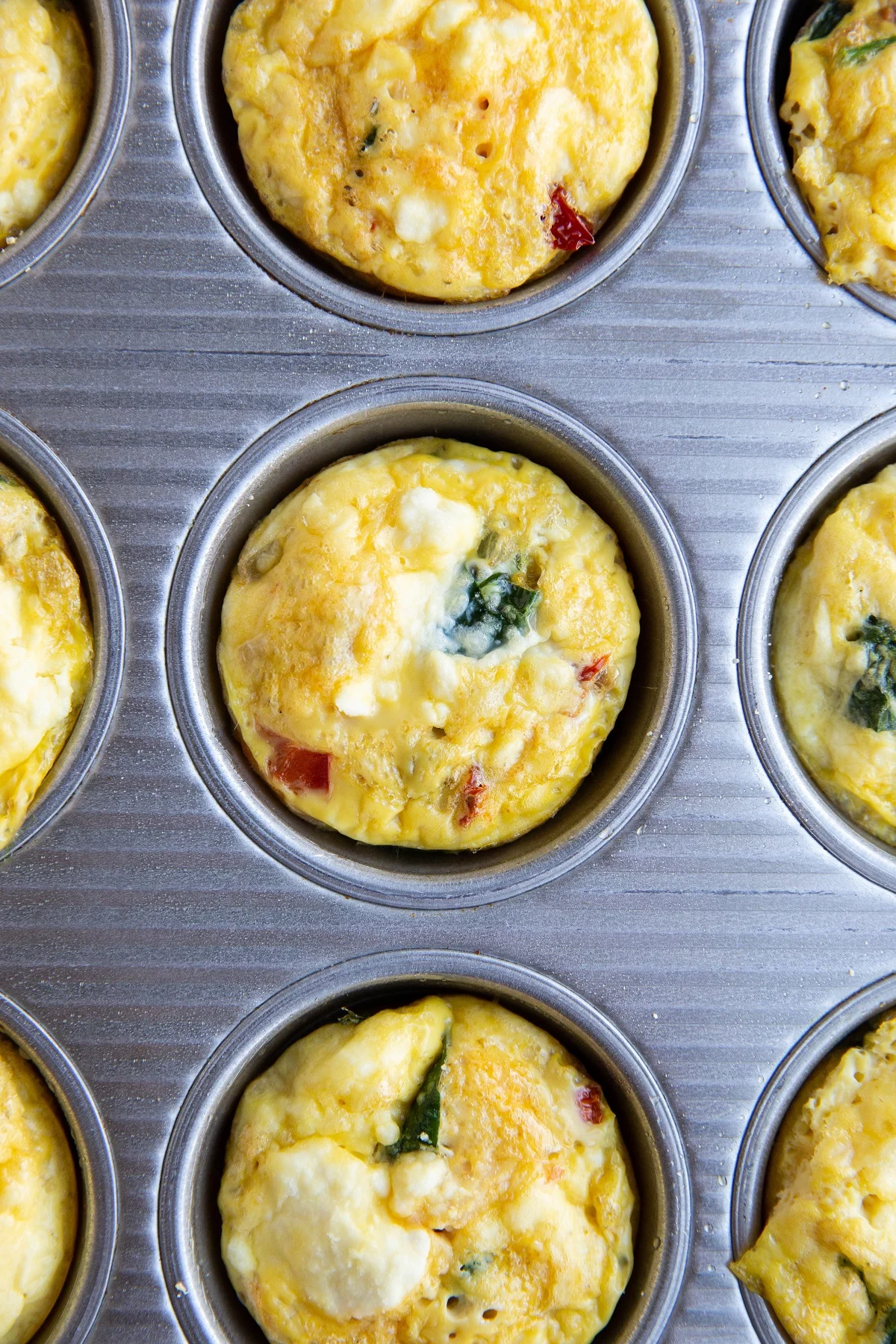 Egg cups in a muffin tin, fresh out of the oven and cooling off.
