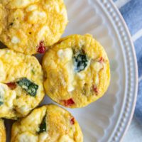 Egg muffin cups on a white plate, ready to serve.