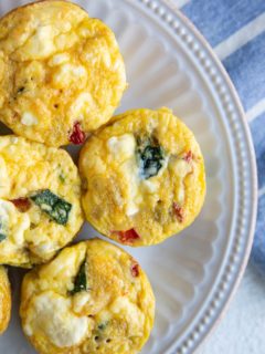 Egg muffin cups on a white plate, ready to serve.