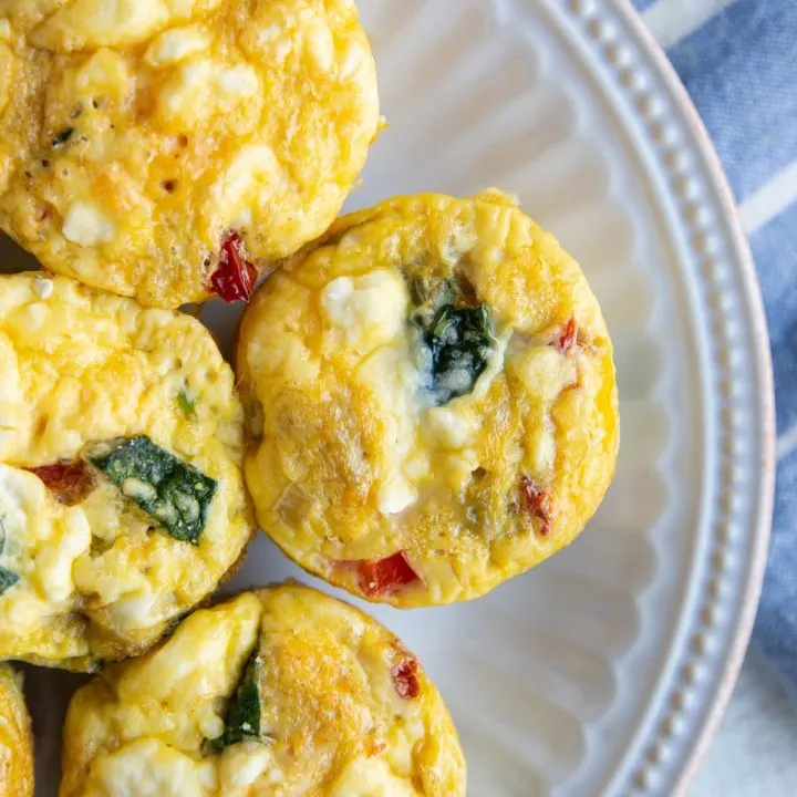 Egg muffin cups on a white plate, ready to serve.