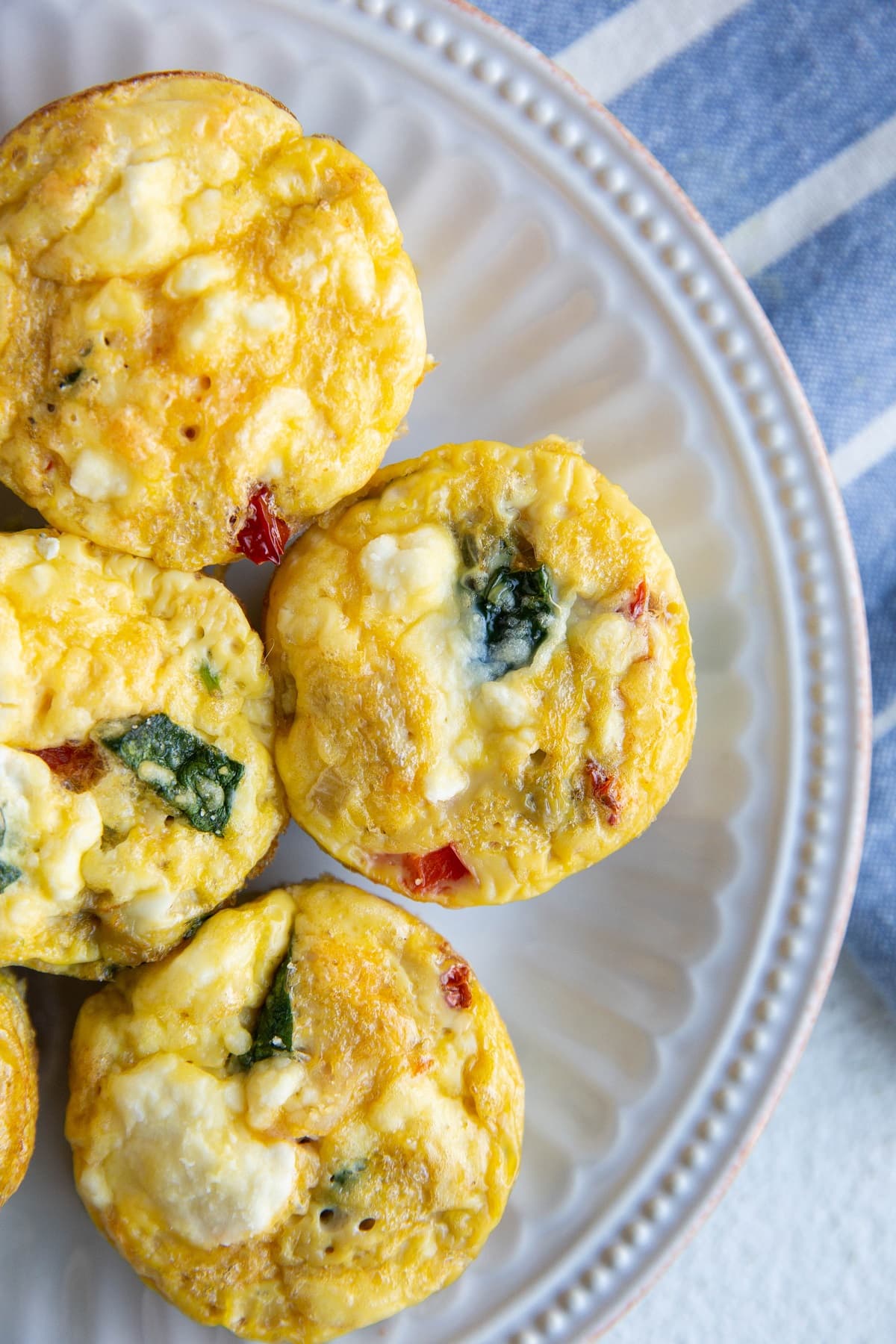 Egg muffin cups on a white plate, ready to serve.