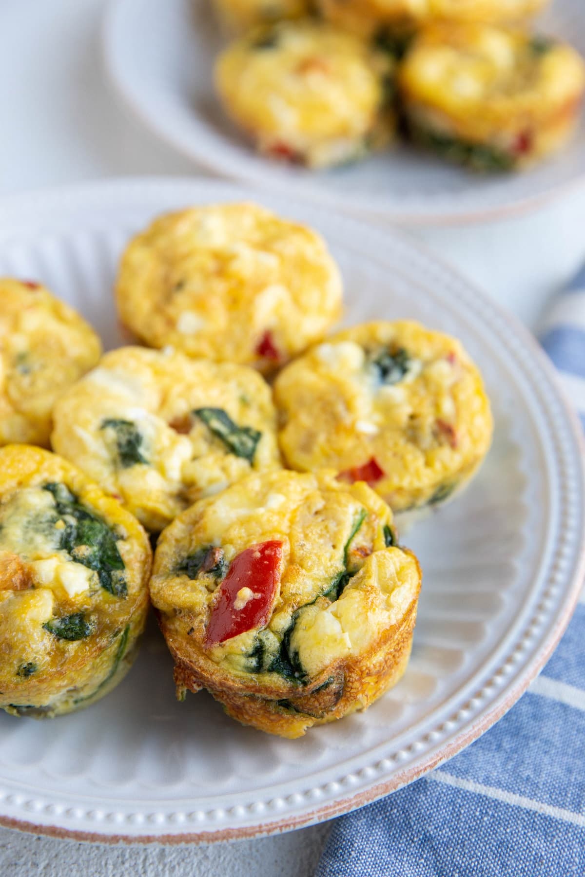 Egg muffin cups on two white plates.