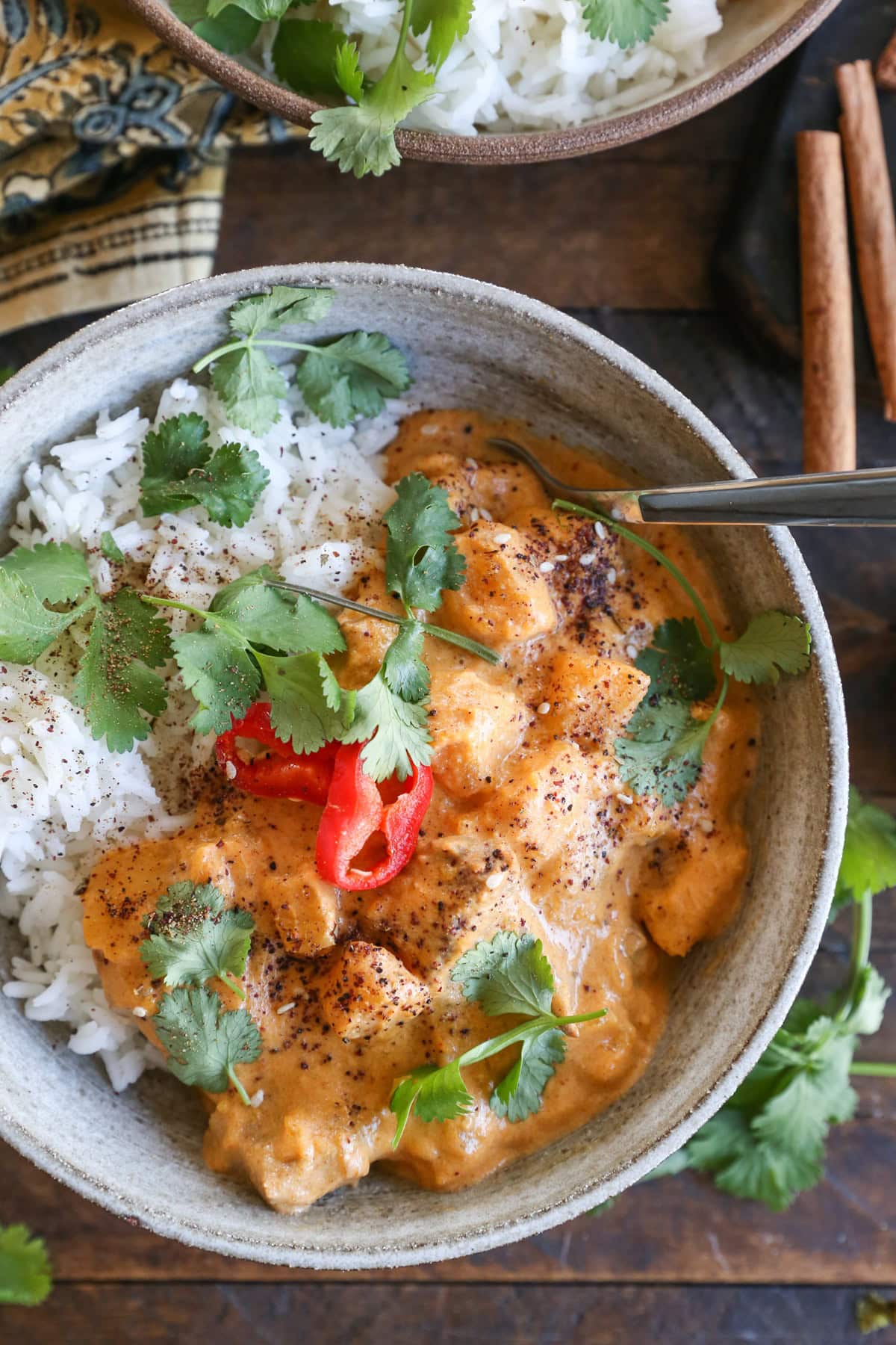 Massaman curry in a ceramic bowl with rice and cilantro