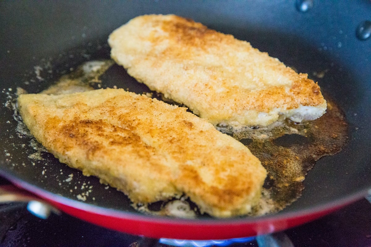 Pan-Fried Breaded Chicken for Chicken Parmesan in a large skillet.