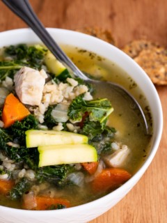Big bowl of chicken soup with rice and kale