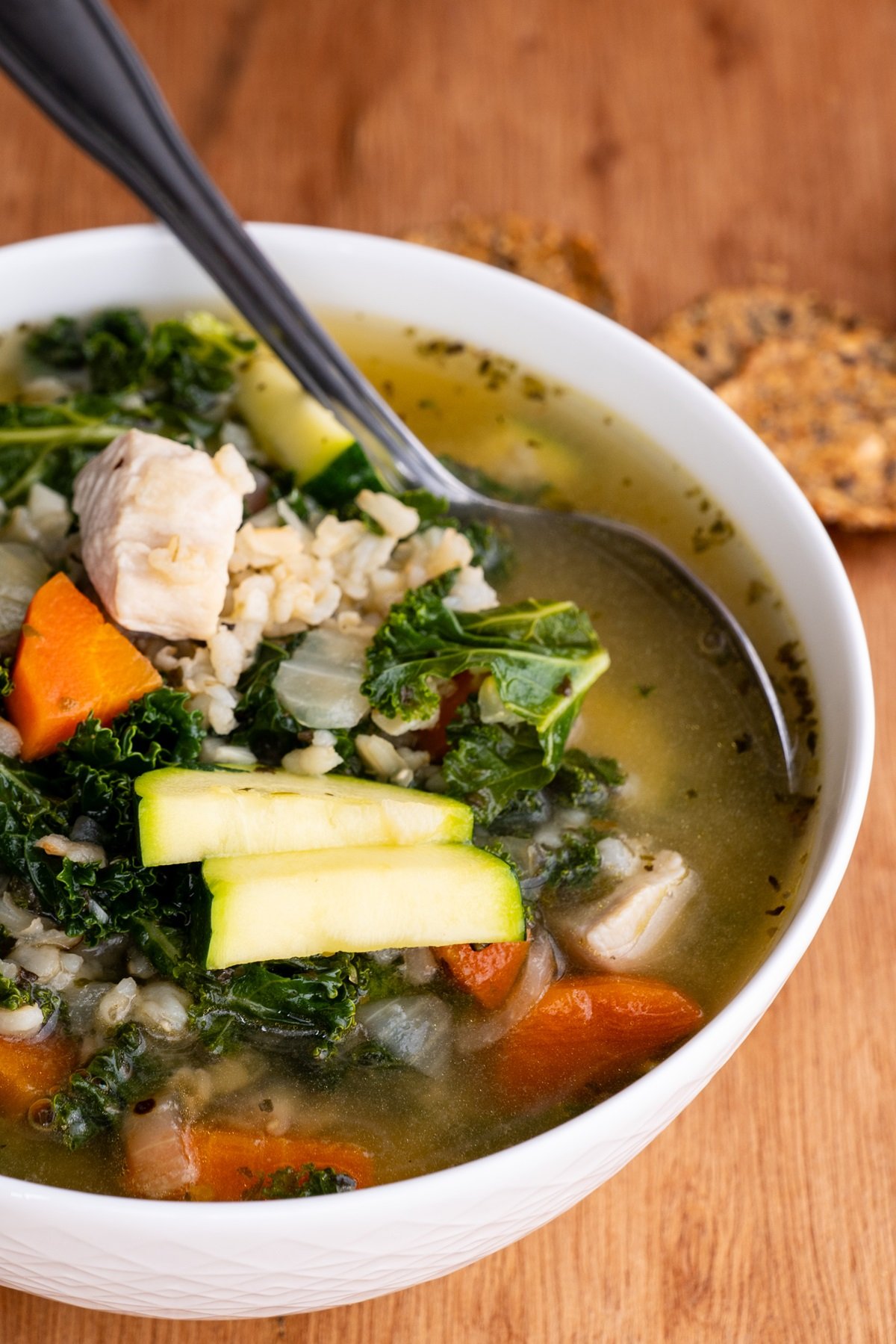 Big bowl of chicken soup with rice and kale