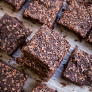 Chickpea brownies cut into slices and sprinkled with chocolate shavings.