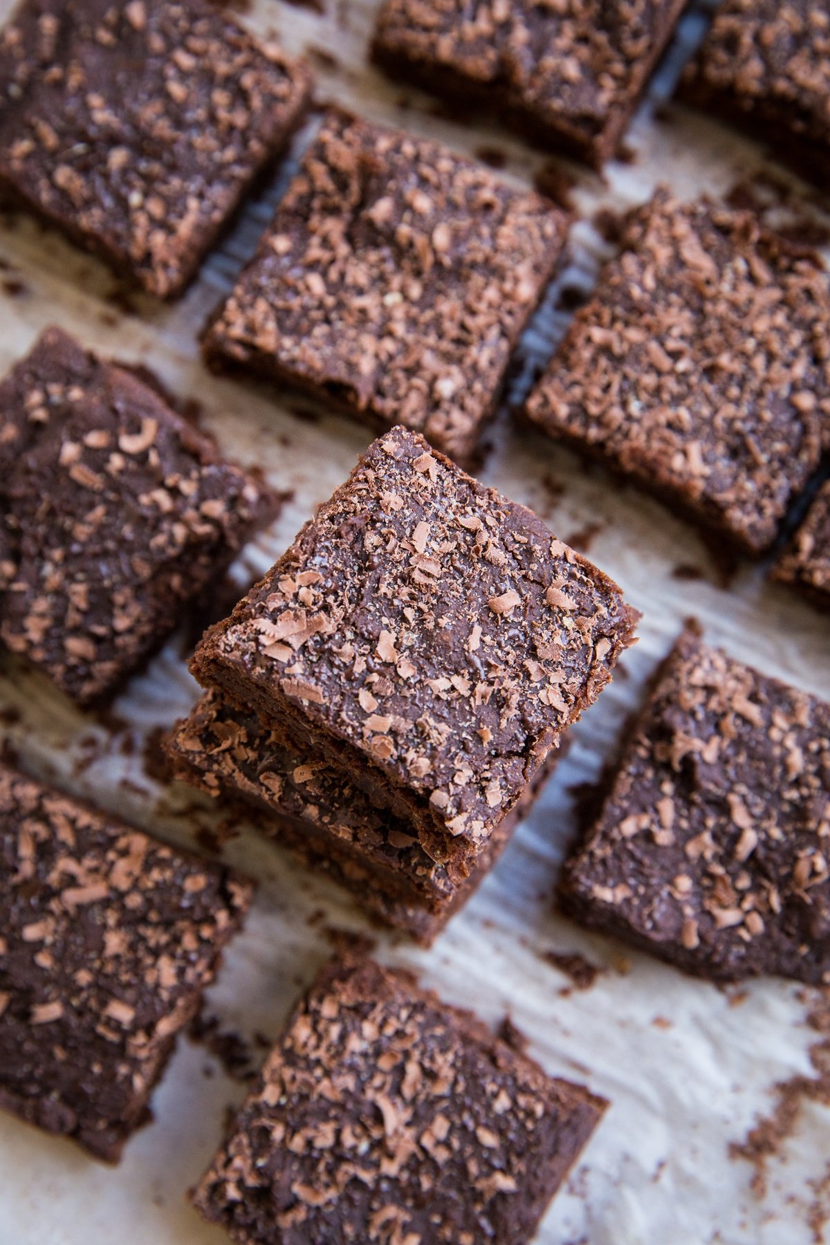 Chickpea brownies cut into slices and sprinkled with chocolate shavings.