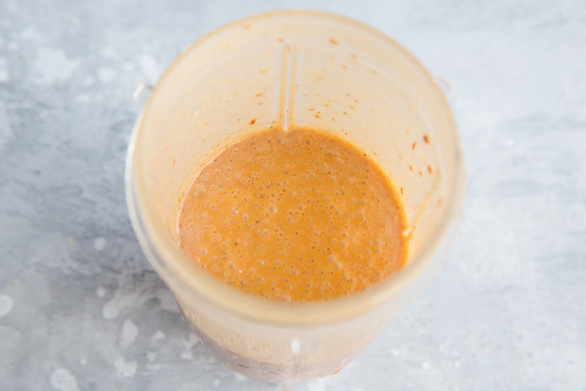 Small blender full of homemade chipotle sauce for dipping fries, ready to use.