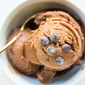White bowl full of chocolate banana ice cream with chocolate chips sprinkled on top. Ready to serve!