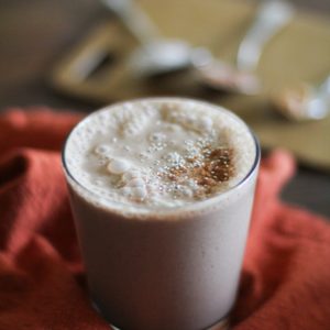 Chocolate Peanut Butter Chia Seed Smoothie in a glass on a red napkin, ready to drink.