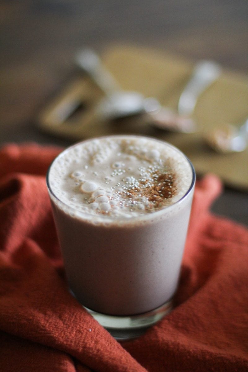 Chocolate Peanut Butter Chia Seed Smoothie in a glass on a red napkin, ready to drink.