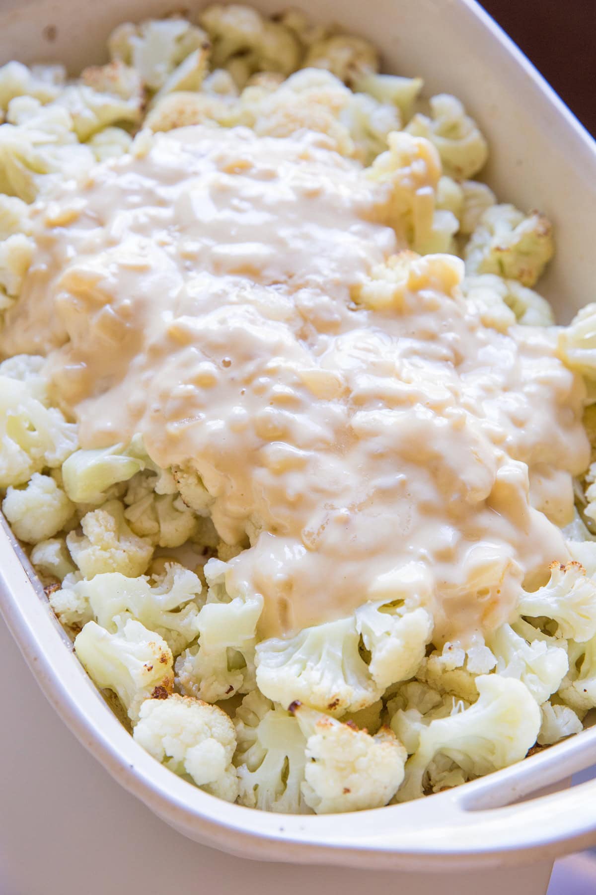Creamy sauce poured on roasted cauliflower