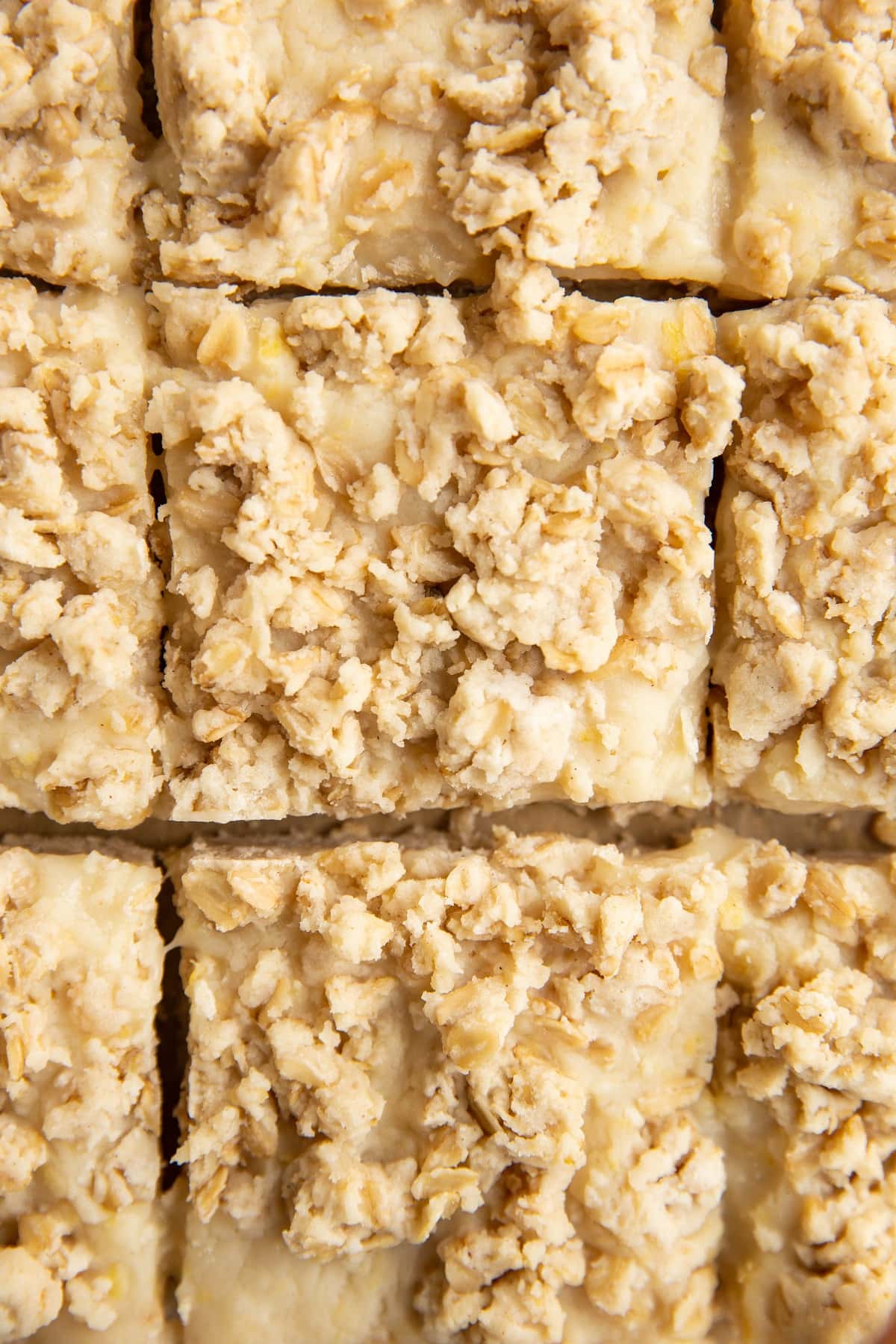 Lemon crumb bars sliced on a sheet of parchment paper, ready to serve.