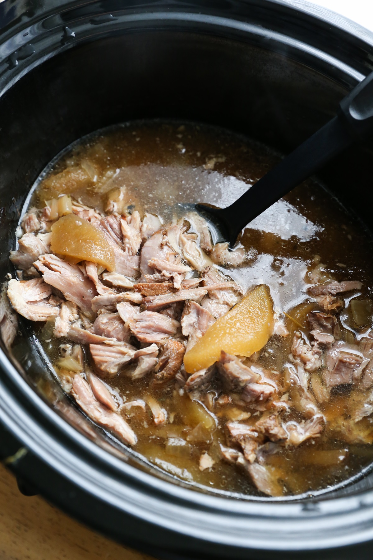 Crock pot full of pulled pork and apples