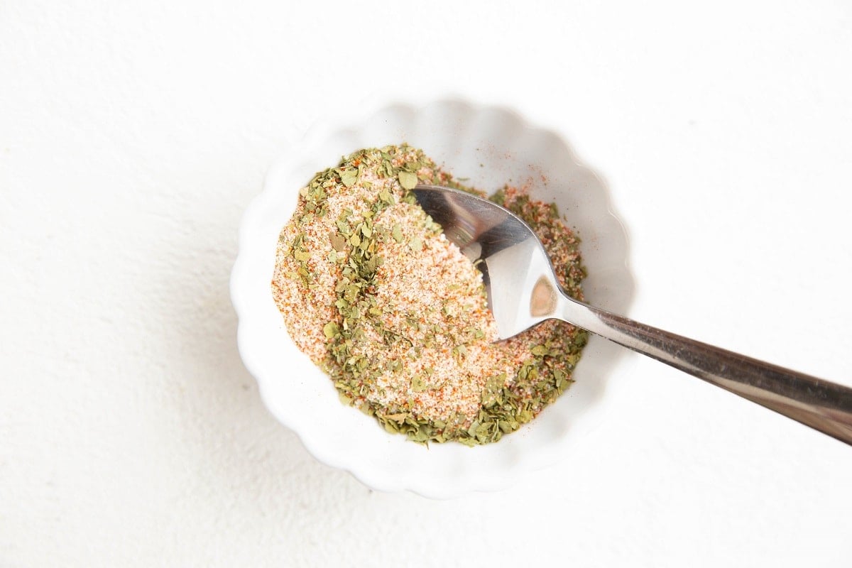 Seasonings for a chicken dry rub in a small bowl.