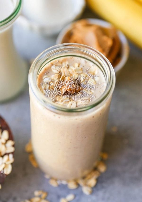 Almond Butter Protein Smoothie with chia seeds, banana, and oats in a glass, ready to drink