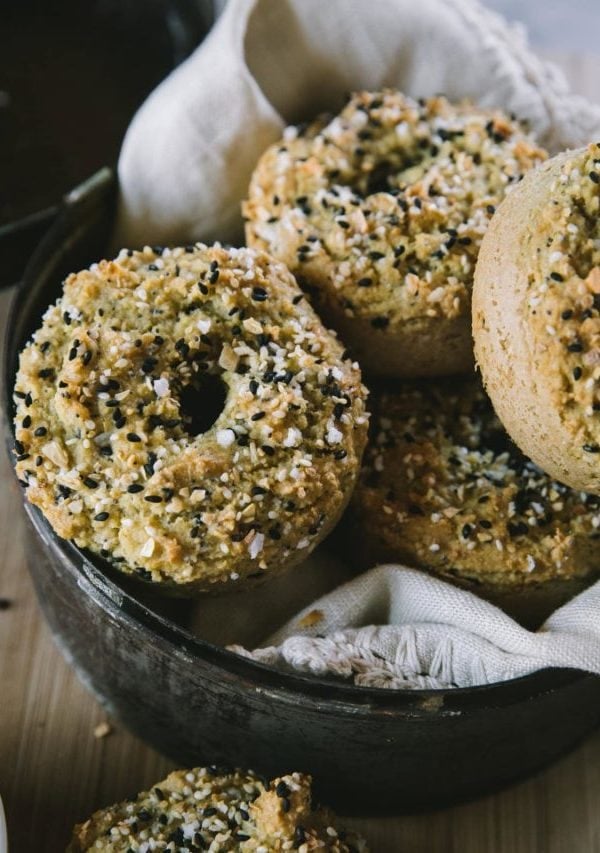 Basket full of almond flour bagels with a linen inside, ready to eat.
