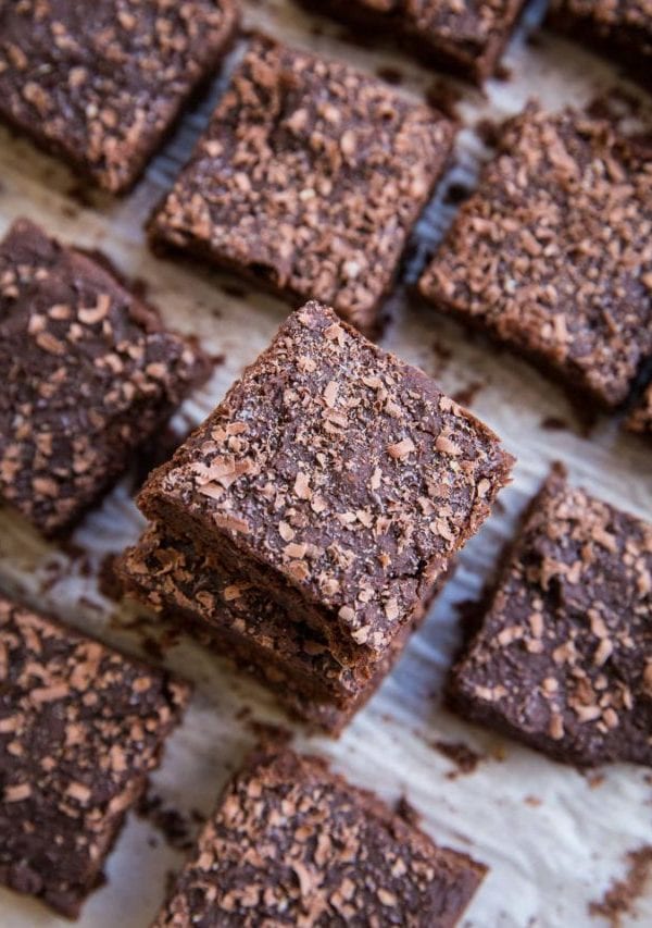 Chickpea brownies cut into slices and sprinkled with chocolate shavings.