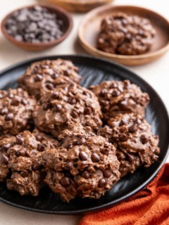 Black plate of double chocolate peanut butter cookies.
