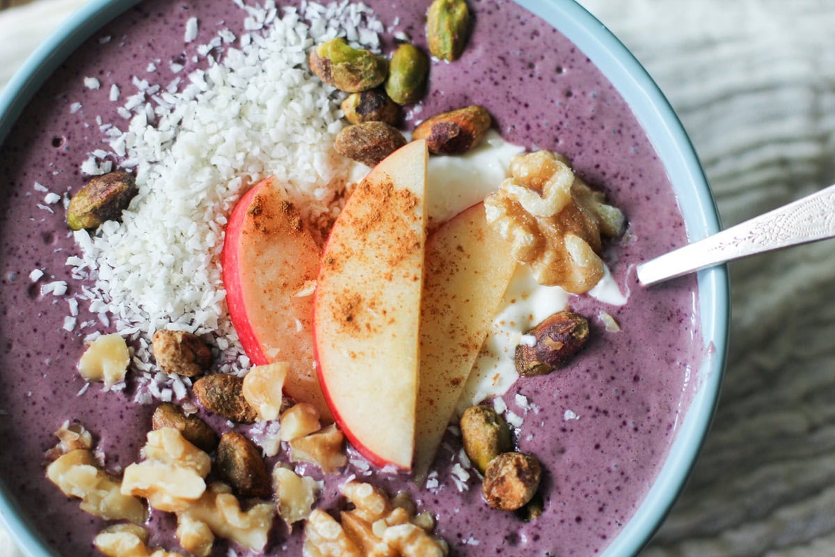 Acai bowl with walnuts, pistachios, sliced apples, greek yogurt