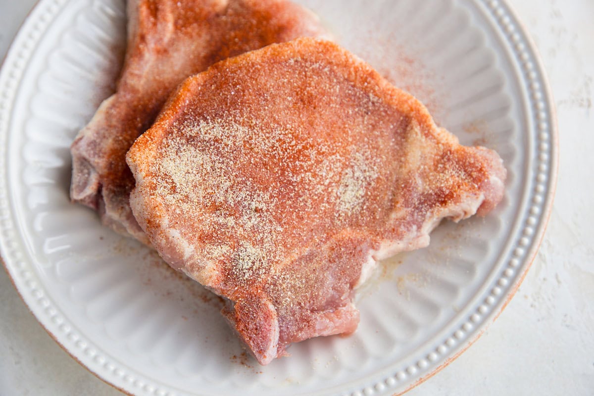 Sprinkle the pork chops with seasonings