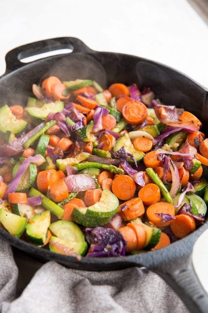 Easy Amazing Sautéed Veggies in a cast iron skillet, ready to be served. Sauteed veggies are the perfect side dish to any meal.