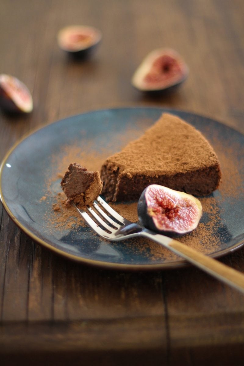 Gluten Free Chocolate Fig Cake on a blue plate with a fork taking a bite out.