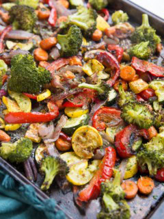 Garlic Herb Roasted Vegetables on a large rimmed sheet pan, fresh out of the oven.