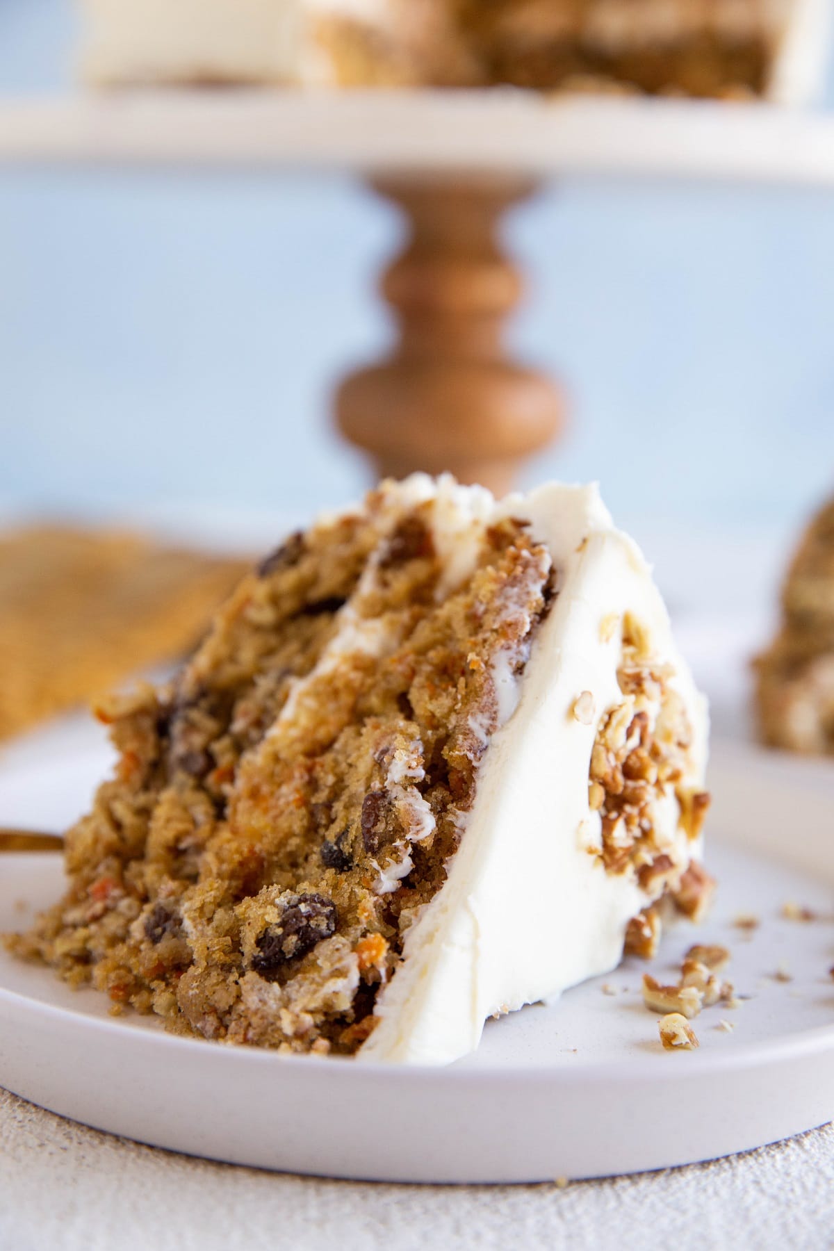 Thick slice of carrot cake on a white plate.