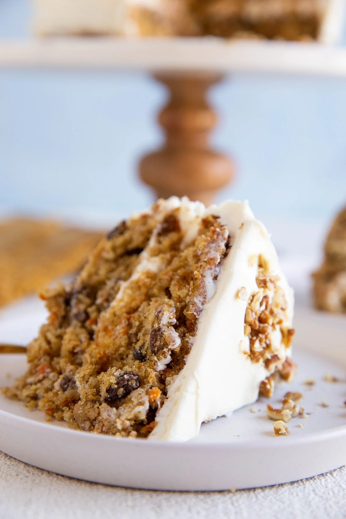Thick slice of carrot cake on a white plate.