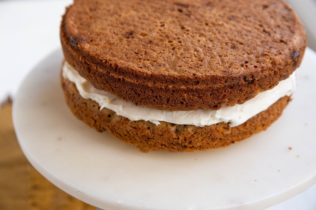 Two layers of carrot cake with frosting in between.