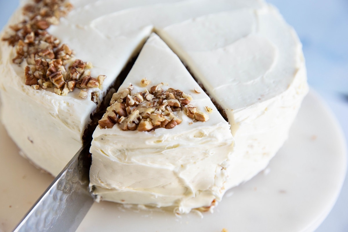 Knife slicing into a carrot cake