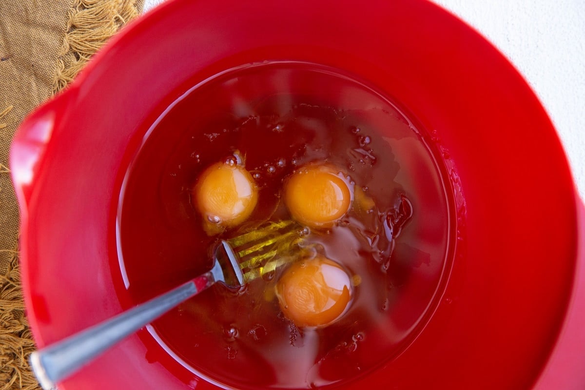 Wet ingredients for carrot cake in a mixing bowl.