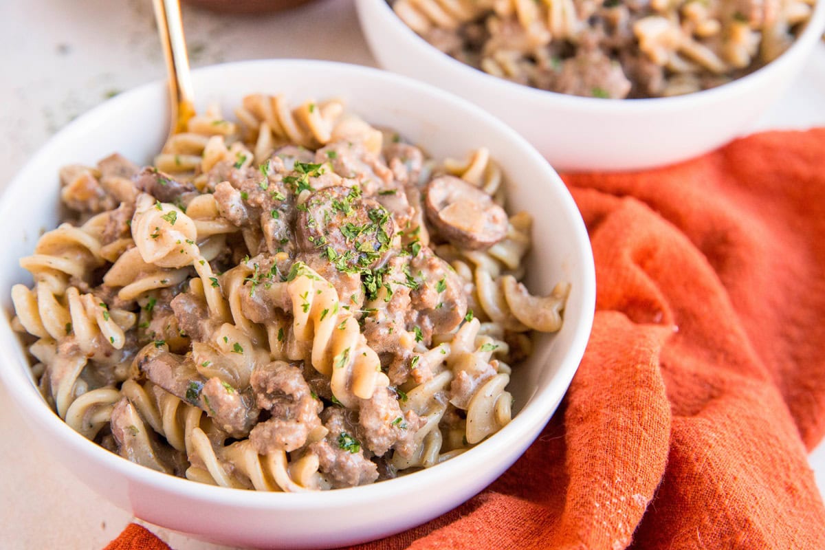 White bowl of gluten-free ground beef stroganoff.