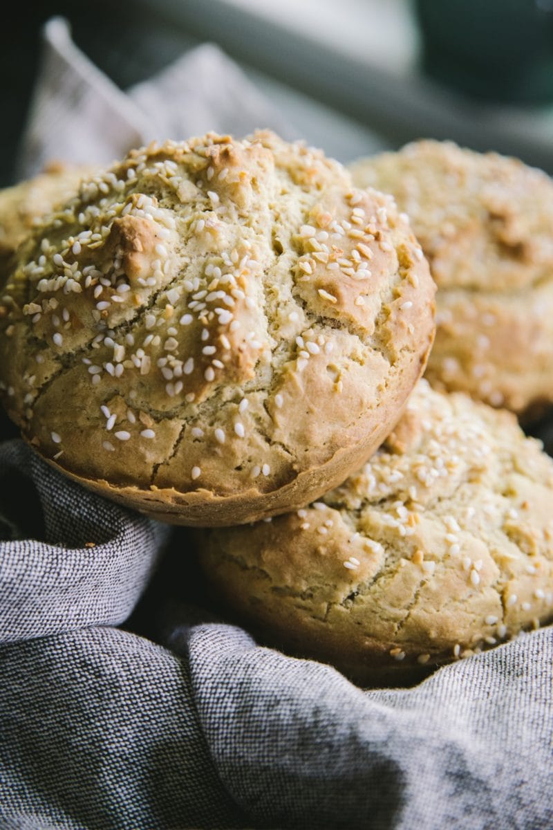 Large gluten-free hamburger buns in a cloth napkin, ready to use.