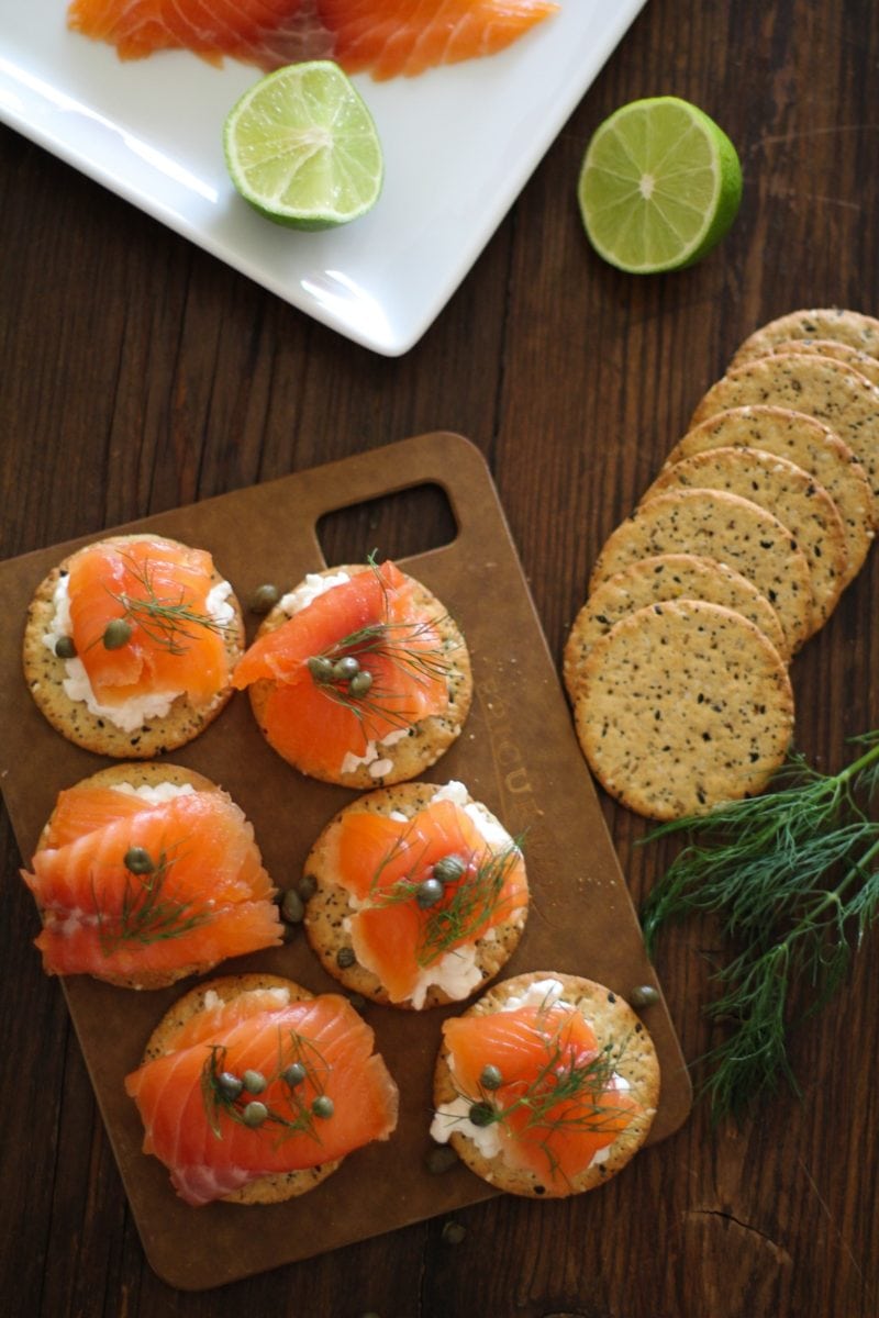 Cured salmon on crackers with fresh dill and capers, ready to serve.