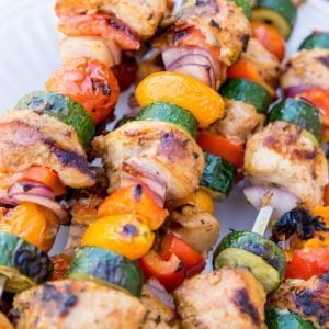 Grilled Chicken Kabobs with Vegetables on a plate with skewers. Ready to serve.