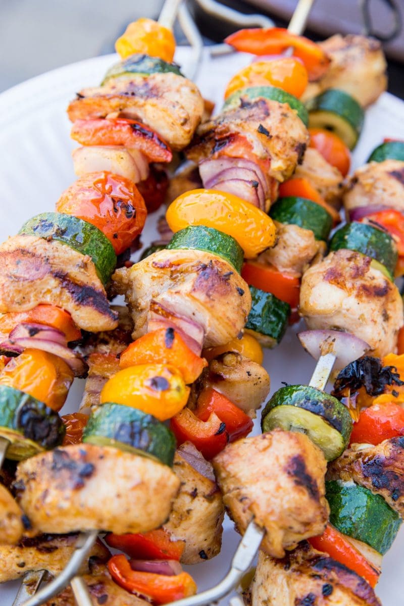 Grilled Chicken Kabobs with Vegetables on a plate with skewers. Ready to serve.