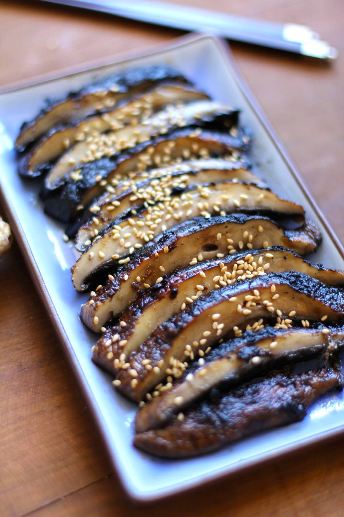 Plate of sliced grilled portobello mushrooms.