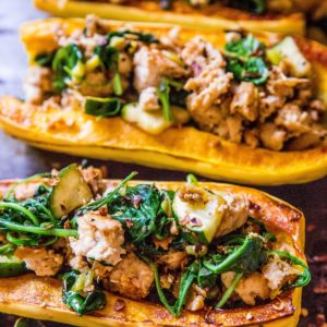 Baking sheet of stuffed delicata squash.