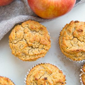 Apple banana muffins on a white background with fresh apples, ready to serve,