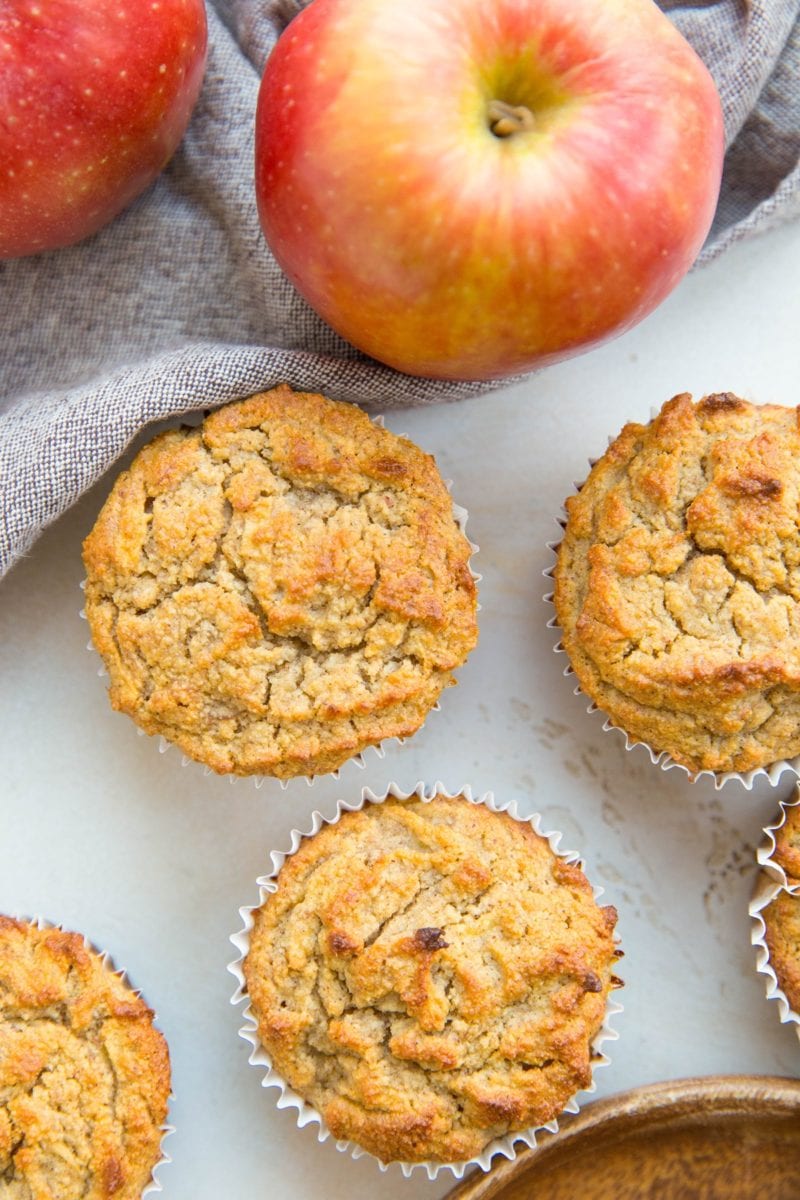 Apple banana muffins on a white background with fresh apples, ready to serve,