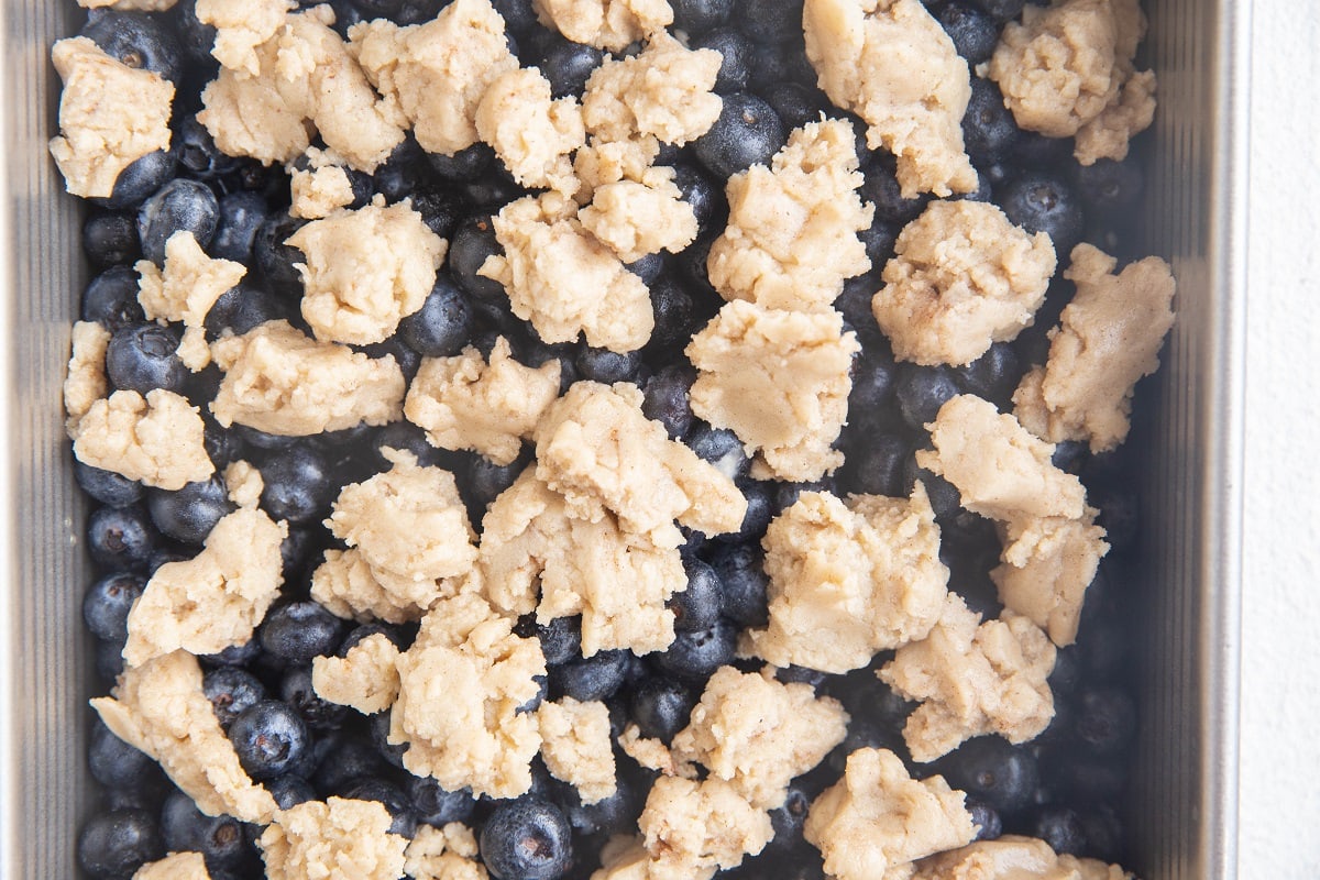 Blueberries in a baking dish with cobbler topping on top.