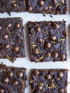 Top down photo of cut zucchini brownies on a white background.