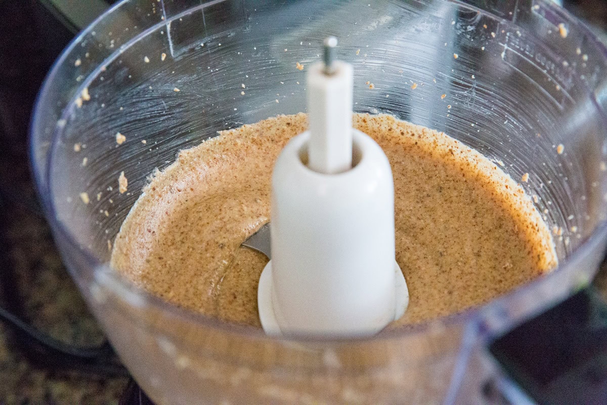 Food processor full of homemade almond butter, ready to use.