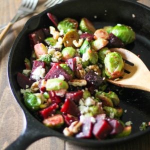 Cast iron skillet of sauteed brussel sprouts and beets, ready to serve.